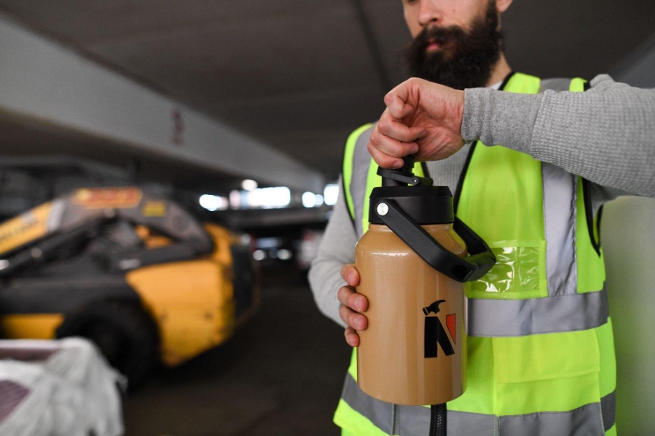 Man holding water bottle wearing safety vest - let employees pick recognition gifts blog cover image