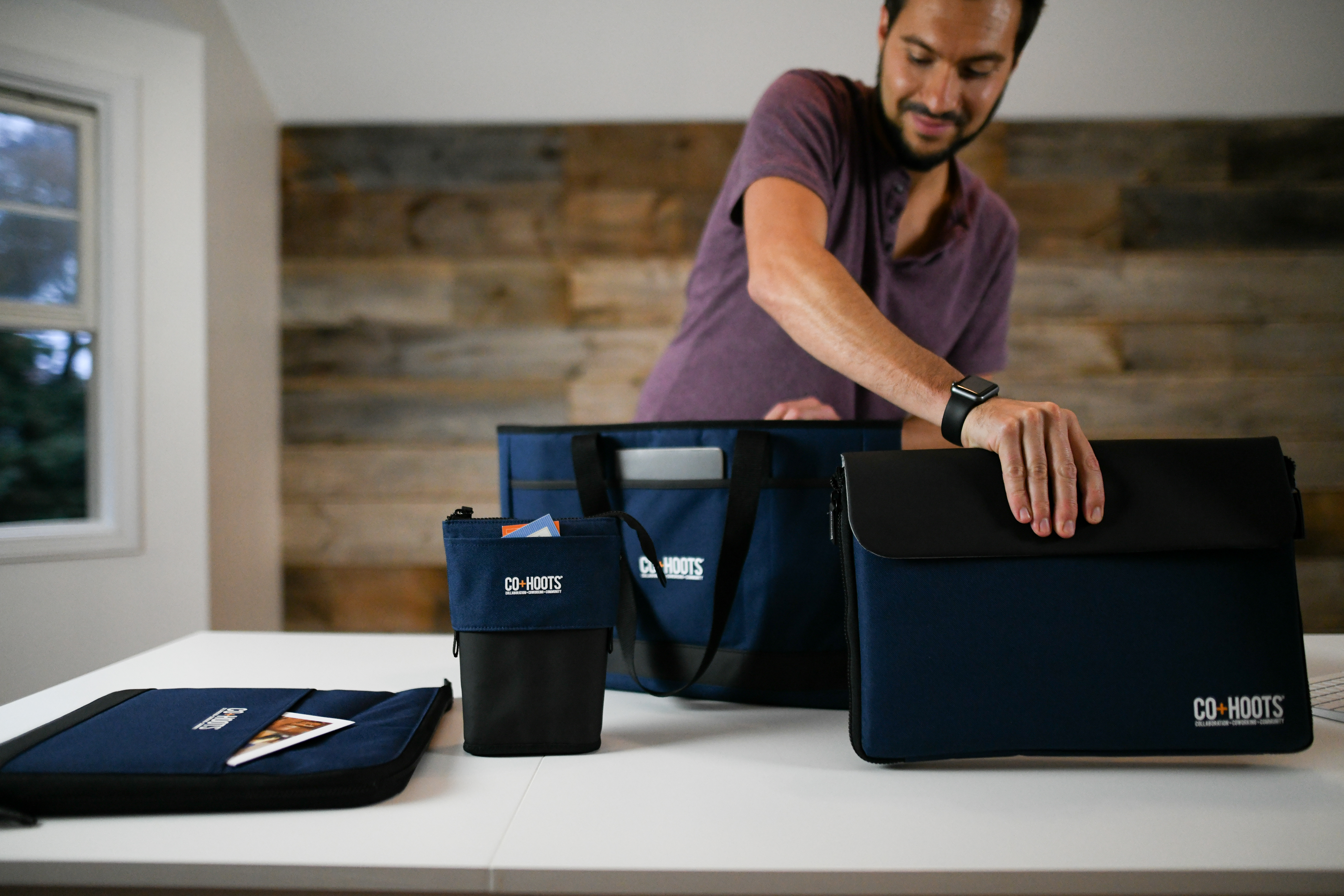 man with an assortment of promotional merchandise